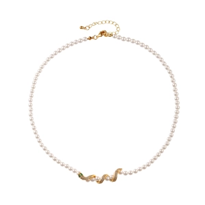 Luxury pearl necklace featuring a gold snake pendant with zircon and green gemstones
