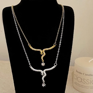 Snake pendant necklace set in gold and silver with sparkling rhinestones on model