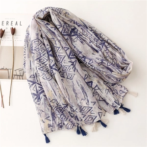Elegant geometric print voile scarf with navy blue tassels and soft linen texture