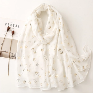 Lightweight white scarf with gold foil swallow prints and minimalist lifestyle props