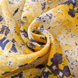 Floral print cotton-linen scarf with bright yellow and blue abstract patterns and tassels