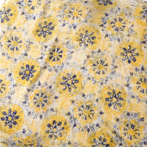 Detailed view of yellow and blue geometric round pattern on retro voile scarf fabric