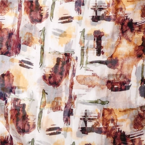 Macro detail of abstract watercolor print on light cotton linen fabric with tassel edges