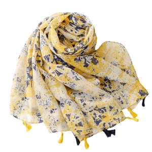 Lightweight cotton-linen scarf with yellow background, navy prints, and tassels