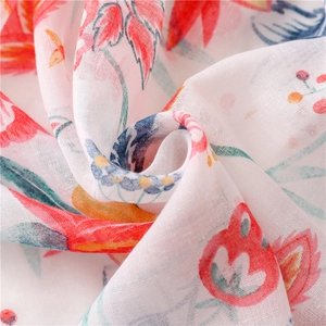 Vibrant floral print scarf made of soft linen-feel cotton voile with tassel details