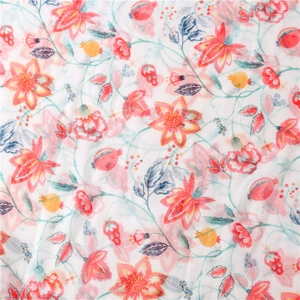 Detailed close-up of vibrant floral and pomegranate print on white linen texture scarf
