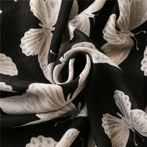 Thick black herringbone cotton linen scarf featuring a delicate butterfly print pattern