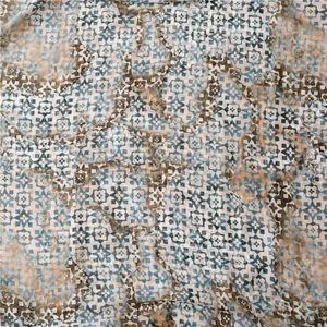 Close-up of geometric floral pattern on a gradient scarf with vintage watercolor texture
