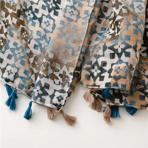 Close-up of geometric mosaic pattern and fringe details on lightweight cotton scarf