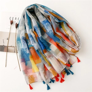 Ethnic style cotton linen scarf with colorful mosaic print and fringe on white background