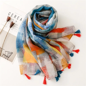 Detailed view of colorful abstract print scarf with tassel edges on white background