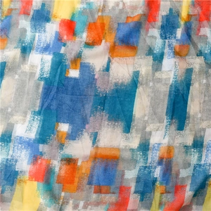 Detailed view of bohemian voile scarf featuring abstract mosaic prints and fringe details