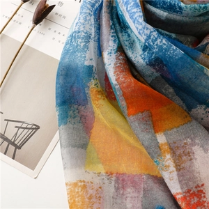 Close-up of lightweight colorful mosaic print scarf with soft textures and fringes