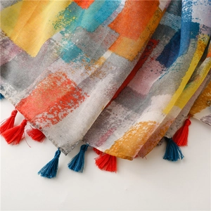 Detail of bohemian voile scarf with colorful mosaic print and vibrant handmade tassels