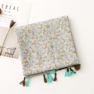 Floral cotton linen scarf with blue and yellow flower prints and tassel trim detailing