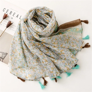Detail of floral printed scarf with multi-color tassels and elegant fringe finish