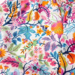 Macro detail of colorful floral pattern on lightweight herringbone cotton linen beach shawl