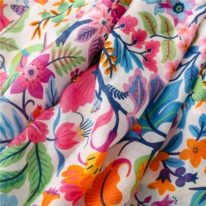 Close-up of colorful floral print fabric with visible cotton-linen herringbone texture