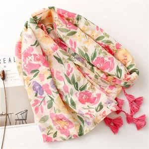 Floral print cotton-linen beach shawl with bright pink tassels on a clean white background
