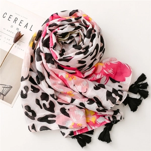 Detail view of tropical floral and leopard print scarf with soft black fringed tassels
