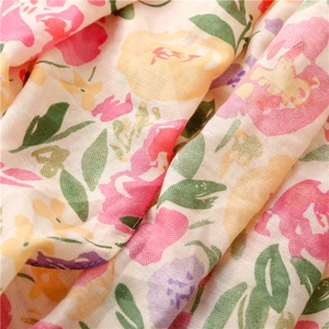 Macro detail of tropical floral print on herringbone textured cotton linen beach scarf