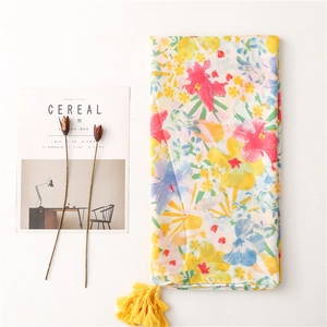 Tropical floral scarf in yellow with tassels and lightweight cotton-linen texture