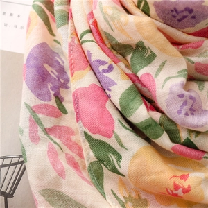 Close-up of tropical floral print on soft linen-feel fabric with herringbone texture