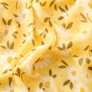 Detailed texture of herringbone cotton linen scarf with bright yellow daisy flower patterns