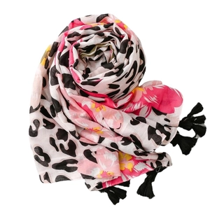 Leopard and floral print scarf with black fringe tassels on a minimalist white background
