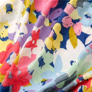 Macro shot of tropical floral print on lightweight fabric with vibrant summer colors