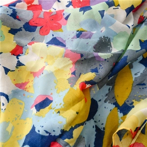 Detail of tropical floral beach shawl showing vivid colors and herringbone weave texture
