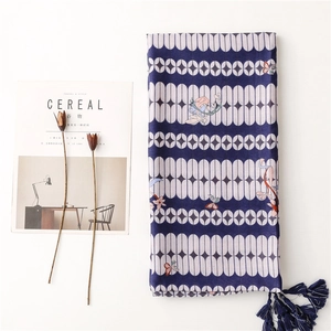 Dark blue geometric scarf with butterfly embroidery and silk tassels on white background