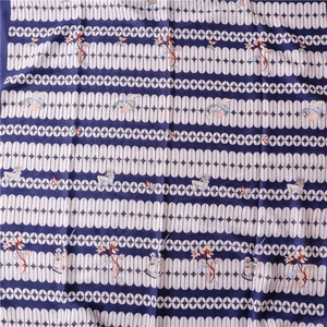 Detailed pattern of navy blue silk scarf with white ovals and fairy illustration