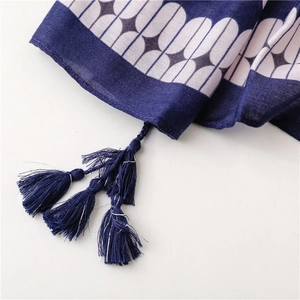 Close-up of geometric pattern cotton linen scarf with handmade dark blue corner tassels