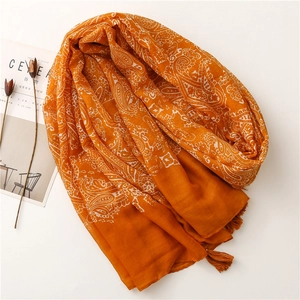 Orange paisley print cotton-linen scarf with elegant tassels on a white background