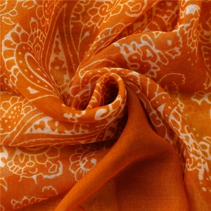 Orange cotton scarf with white paisley pattern and soft textured weave details
