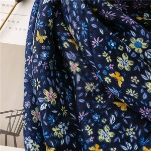 Detailed macro view of the navy cotton linen scarf with butterfly and floral prints