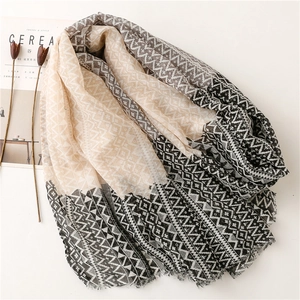 Elegant cotton linen scarf with geometric triangle patterns and fringe trim detail