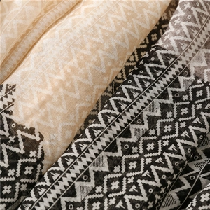 Detailed close-up of bohemian geometric patterns on lightweight cotton linen scarf
