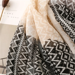 Macro view of geometric pattern cotton linen scarf with frayed edges and soft texture