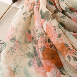 Close-up of lightweight linen-feel scarf with vintage floral print and fine texture