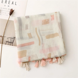 Detail of beige cotton linen scarf with abstract morandi shapes and pink tassels