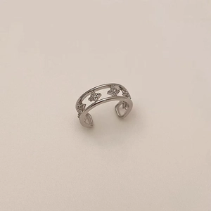 Detail of silver ear cuff featuring double layers and star-shaped zircon inlays