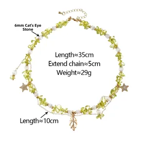 Detail of beaded necklace with green stones, white cat eye beads and star leaf charms