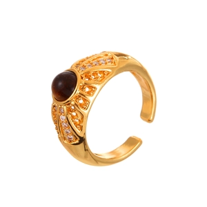 Vintage gold-plated ring featuring tiger eye stone and zircon accents on white background