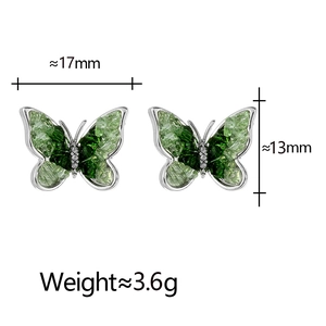 Detail view of butterfly studs with green crystals and white micro-diamonds showing 17mm size