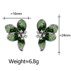 Detailed view of flower earrings with green crystal petals and sparkling stone centers