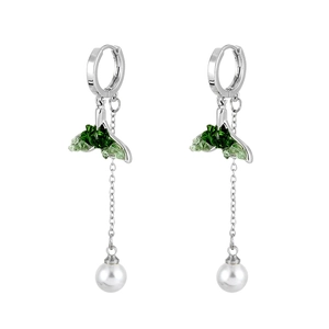 Detail of silver drop earrings with green crystal fishtail and hanging white pearl