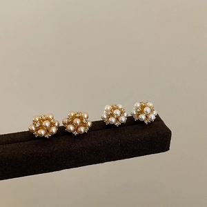Elegant gold flower pearl stud earrings set with sparkling cubic zirconia accents
