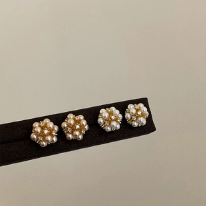 Detail of flower cluster stud earrings with champagne pearls and sparkling crystals